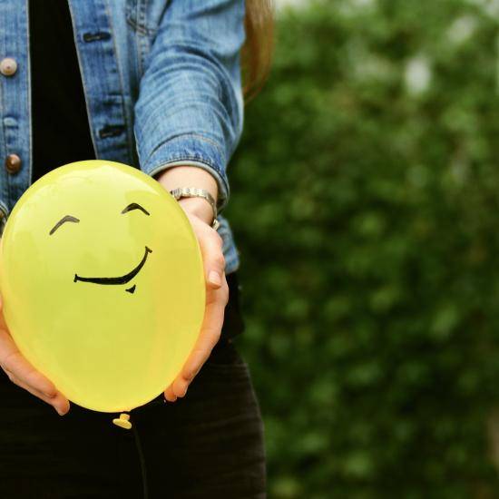 Yellow balloon with a smiley face
