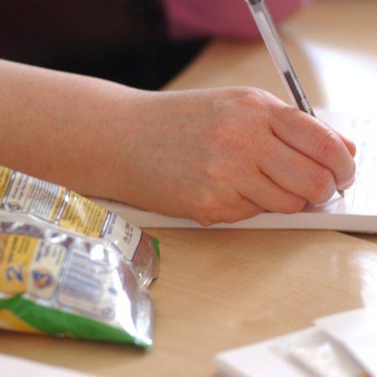 Picture of a hand writing a note