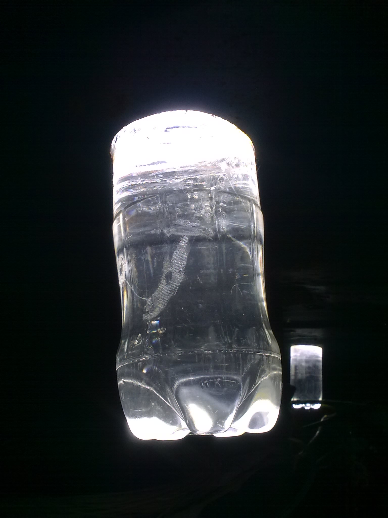 Plastic bottle full of water installed in ceiling as light bulb