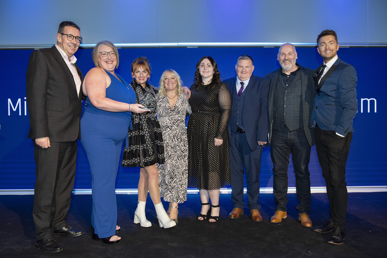 The Millview Cottage Residential Care Team, Dundee City Council team in front of a blue banner