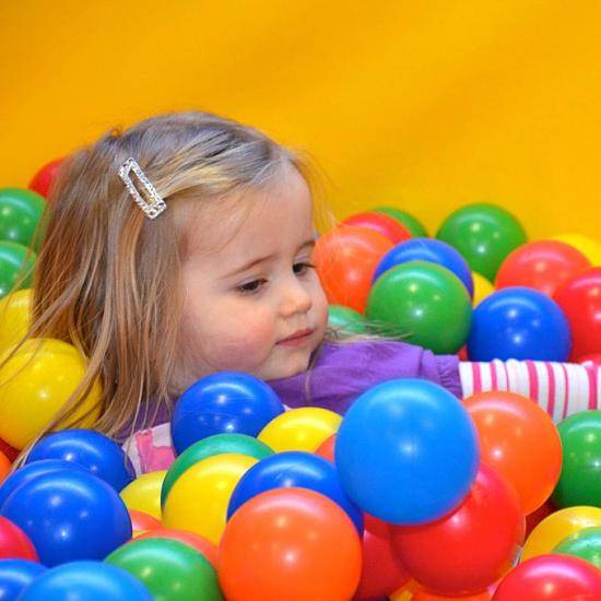 Young child playing in ball pit