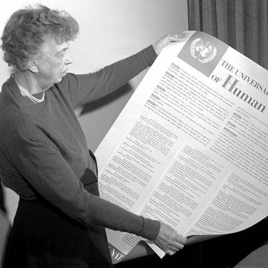 Woman holding over-sized printed version of the Human Rights Act