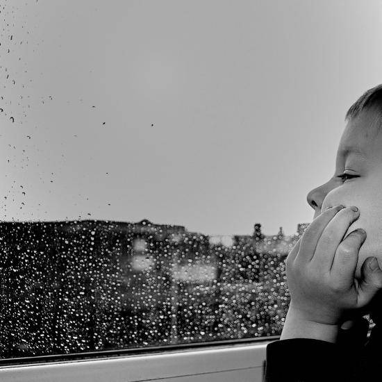 Child at rainy window