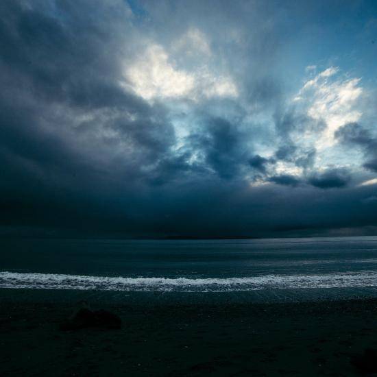 Beach at night with dark clouds