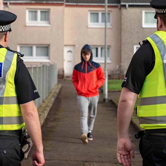 Child about to be arrested by two police officers