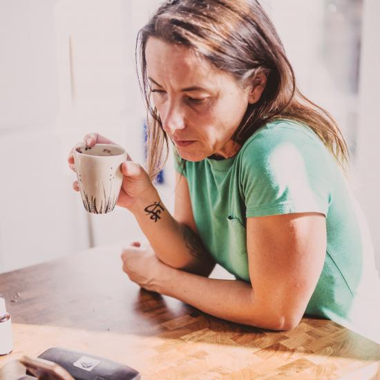 Woman with hot drink on video call