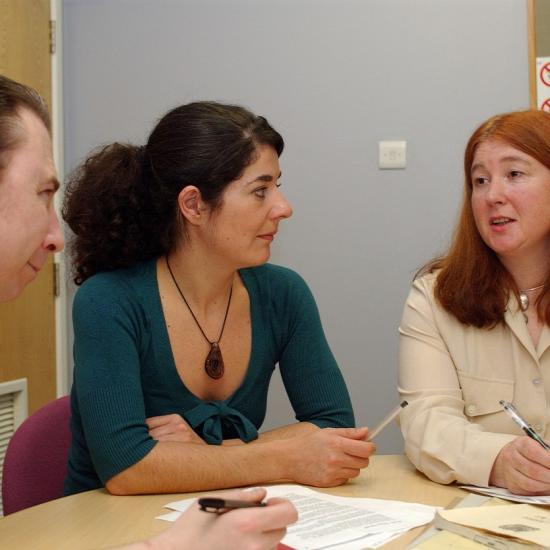 Three people sitting at a table