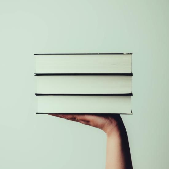 Pile of books in a hand