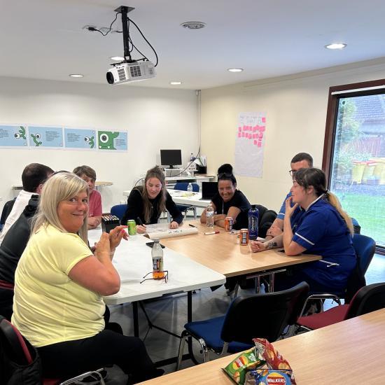 Care home staff discussing the role of paperwork