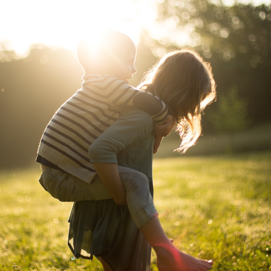 a child receiving a piggyback from another child