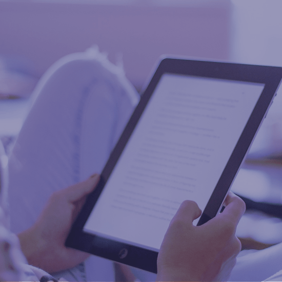 a computer tablet being held
