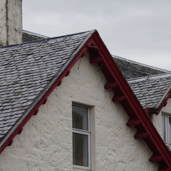 a second story window under a red lintel