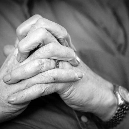 Older person wringing hands