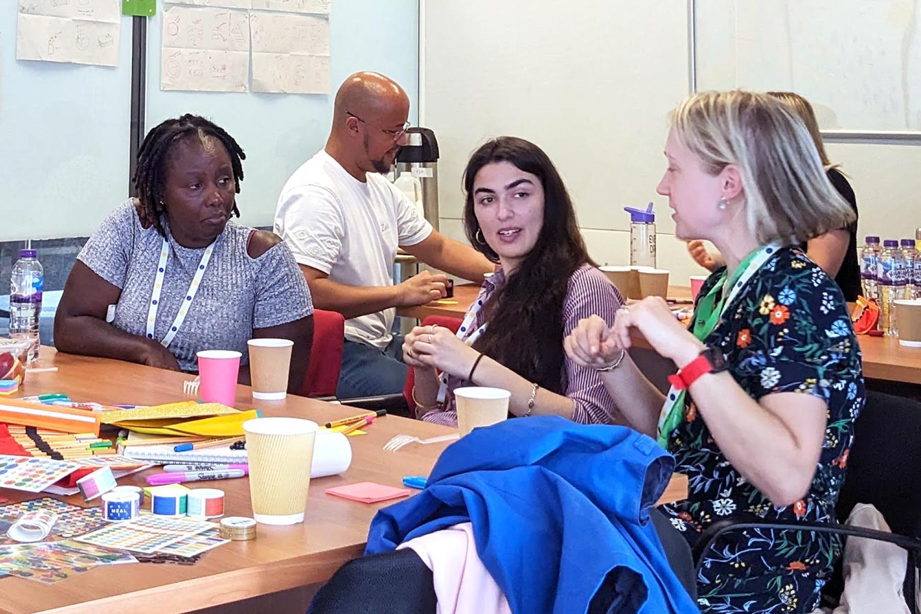 Four women and one man in workshop activity