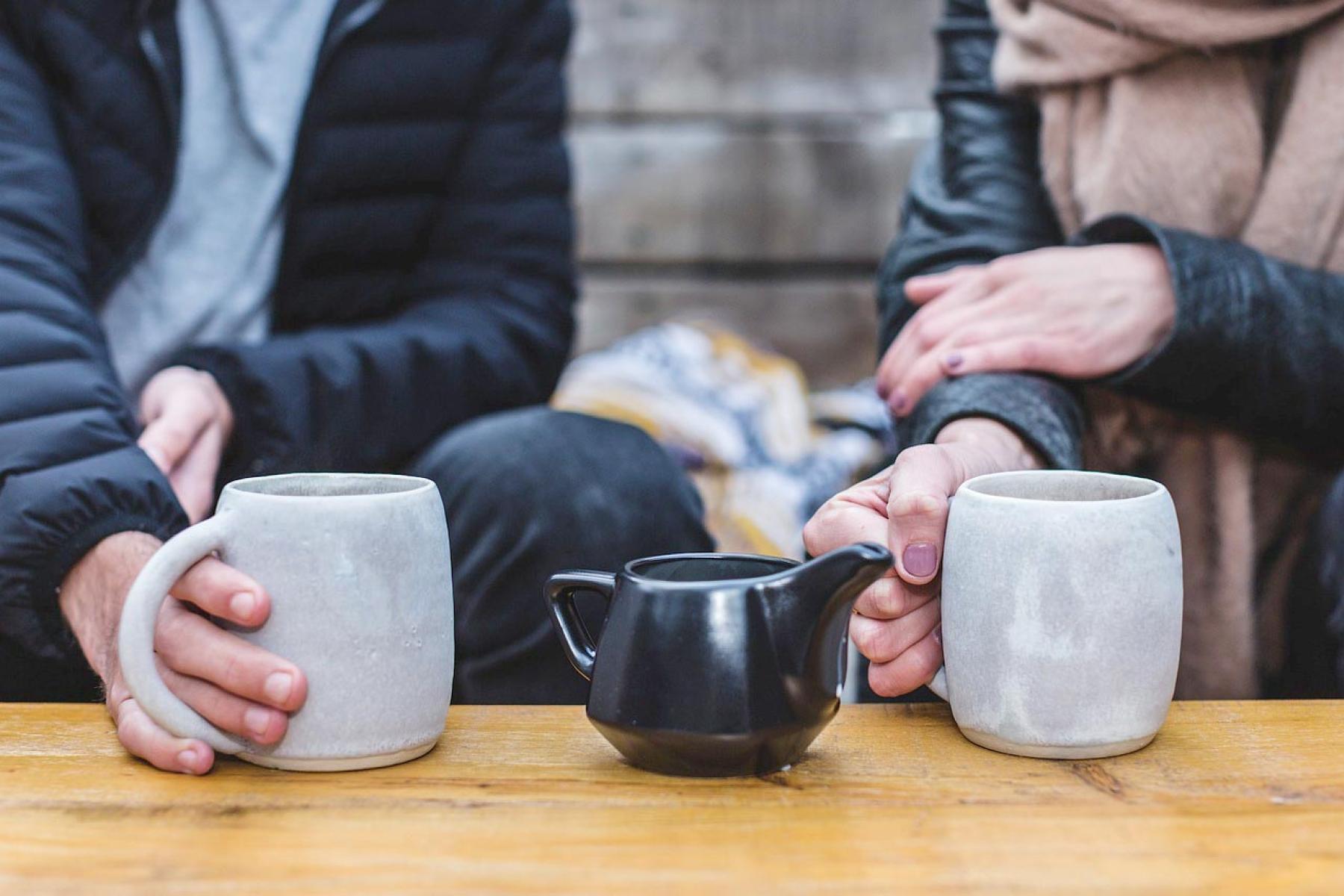 Man and woman sharing tea in comfortable setting