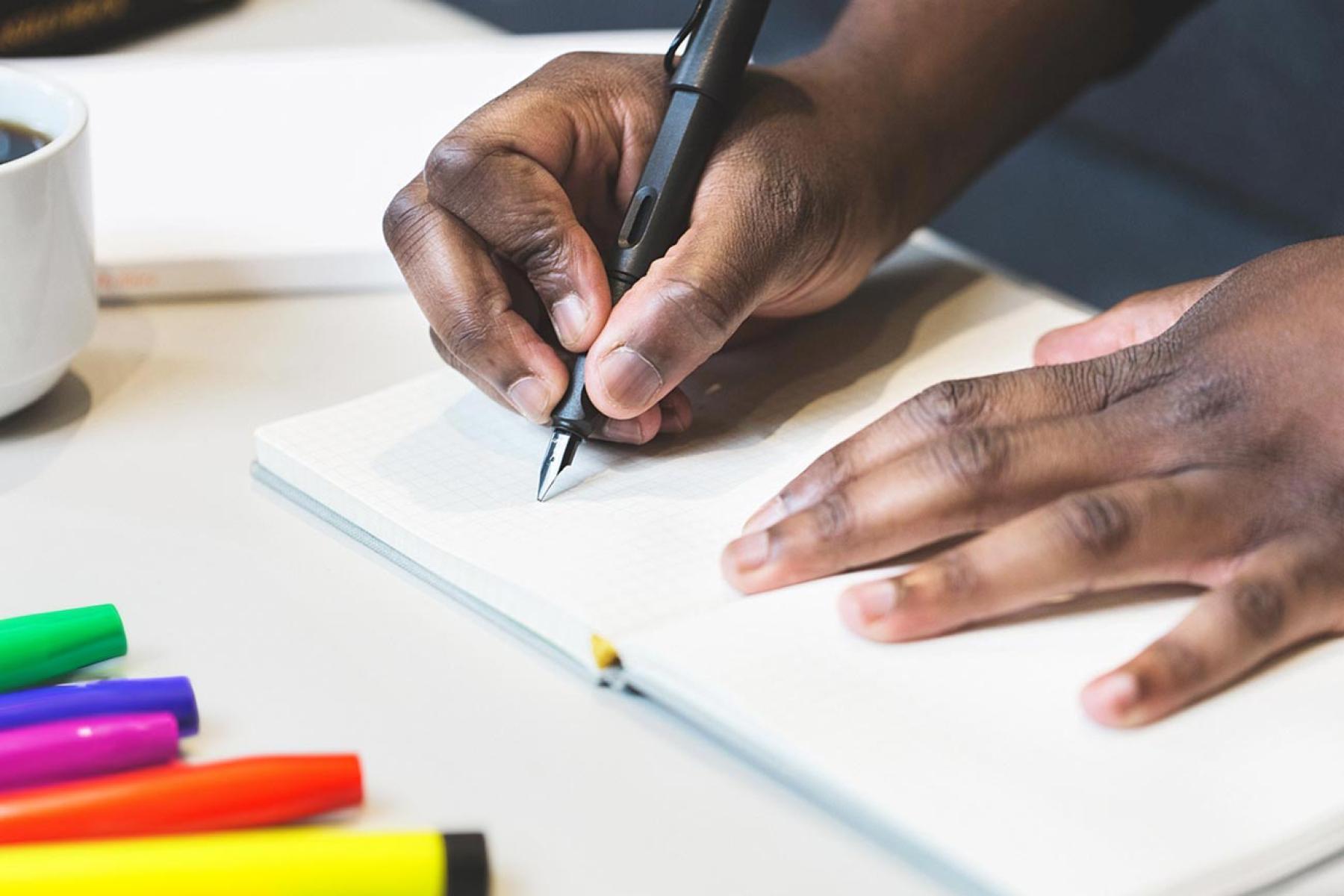 Man writing in note book