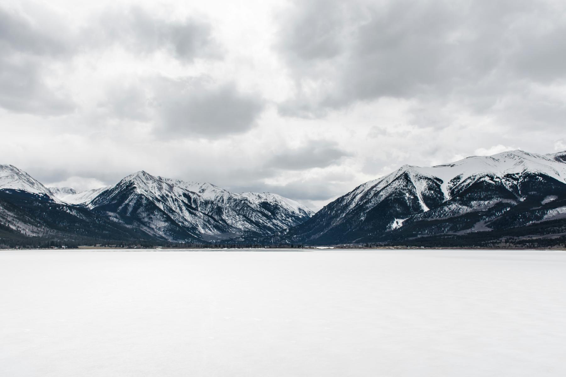 A snowy mountain range and a lake