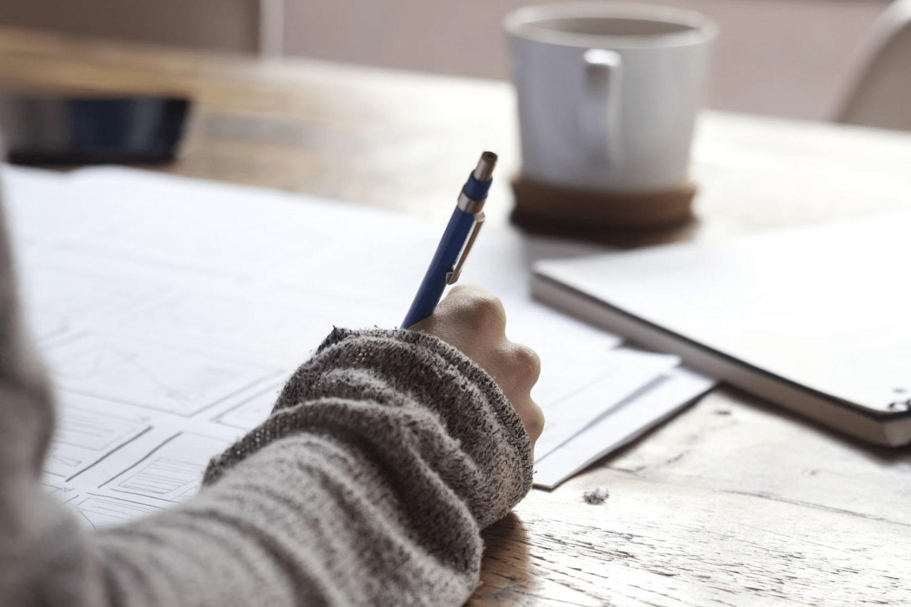 picture of a person writing with a pen