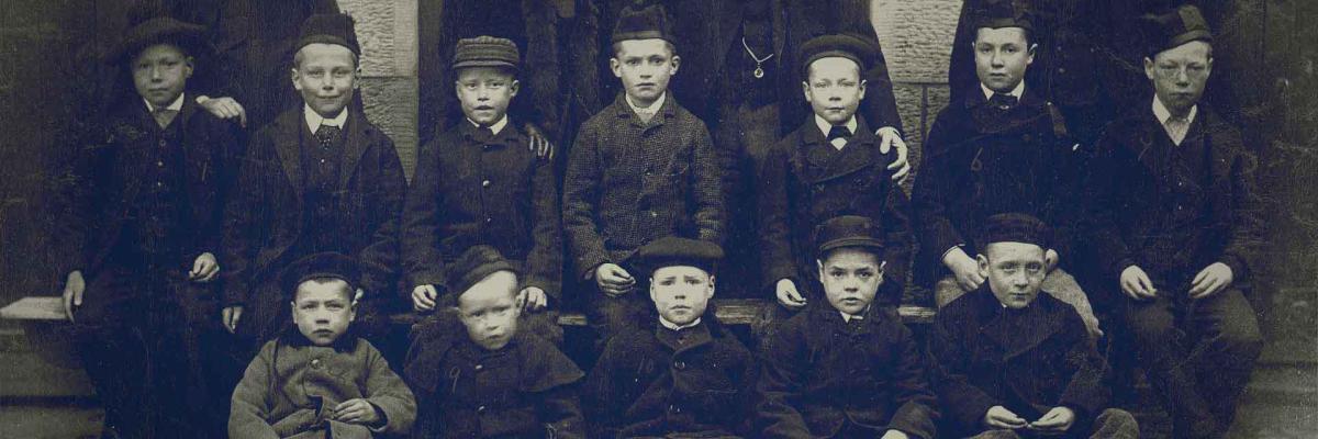 Vintage faded image of group of orphan children outside home
