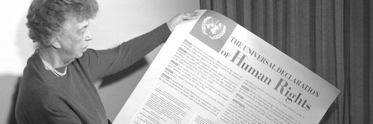 Woman holding over-sized printed version of the Human Rights Act