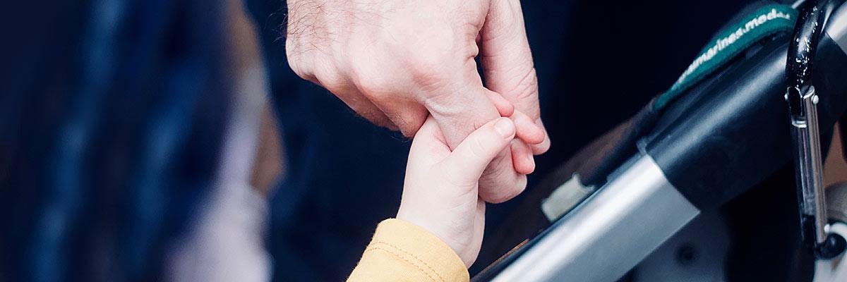 Adult and child holding hands