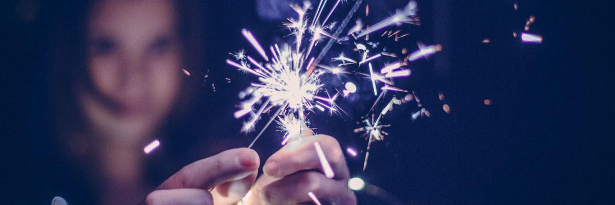 Person holding a lit sparkler