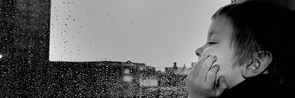 Child at rainy window