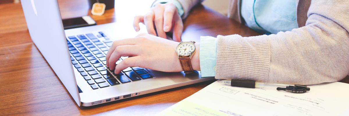 Student typing on a laptop