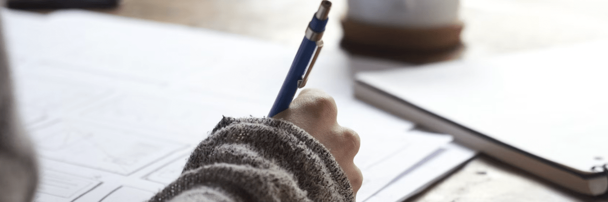picture of a person writing with a pen