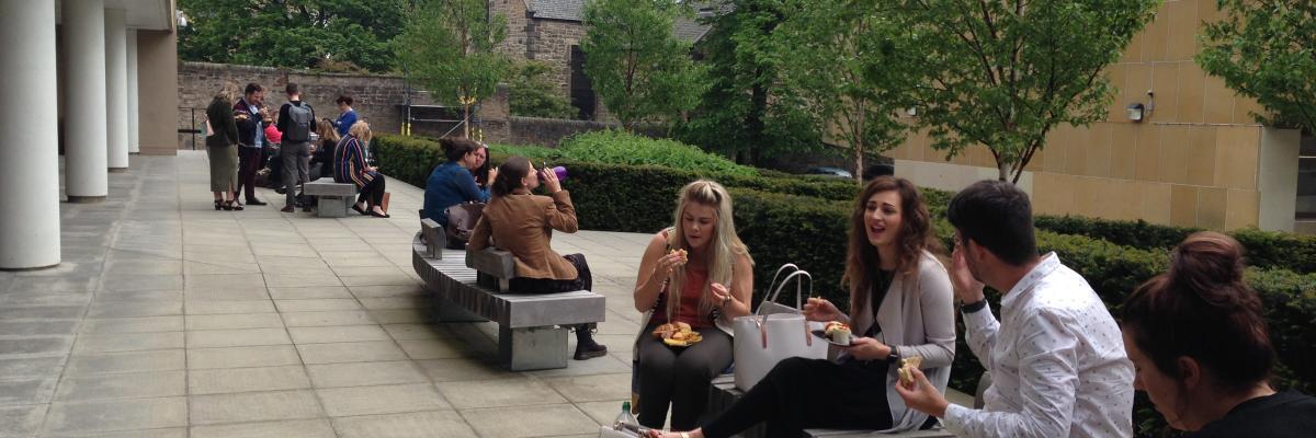 Students sitting having lunch outside