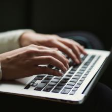 person typing on laptop