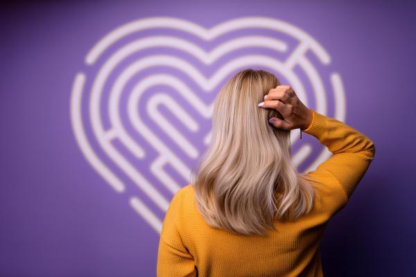 Woman looking at image of a maze shaped like a heart