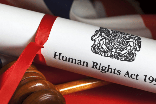 The Human Rights Act rolled up, tied with a ribbon