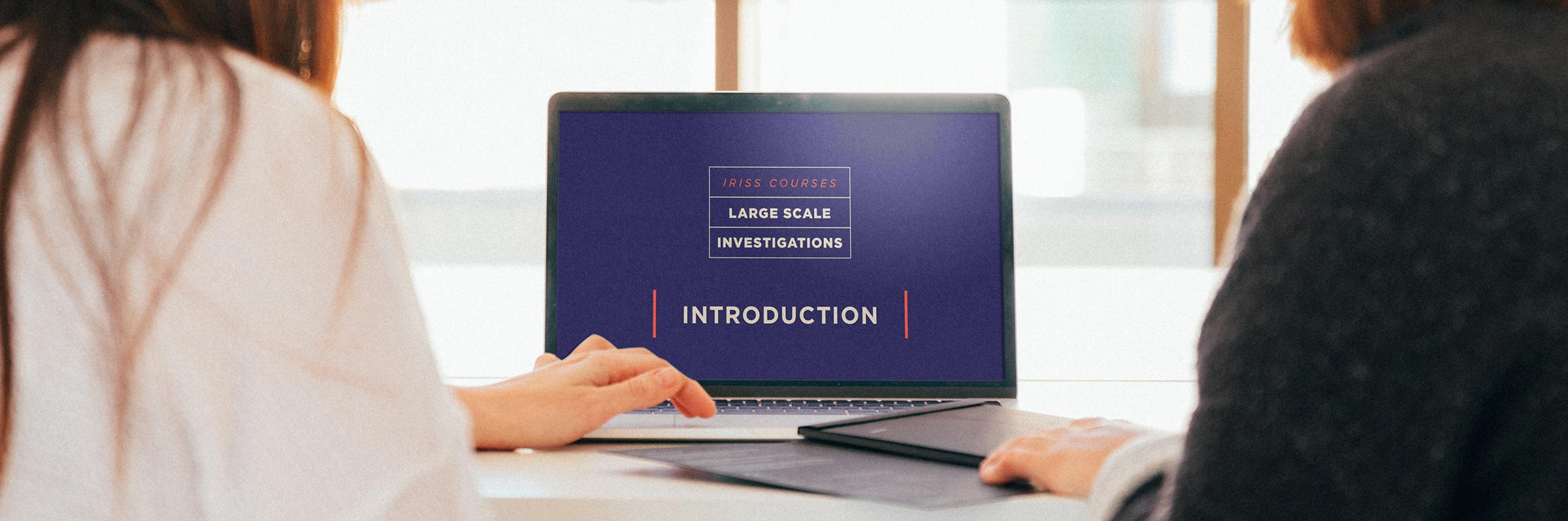 Two women completing online large-scale investigation learning resource